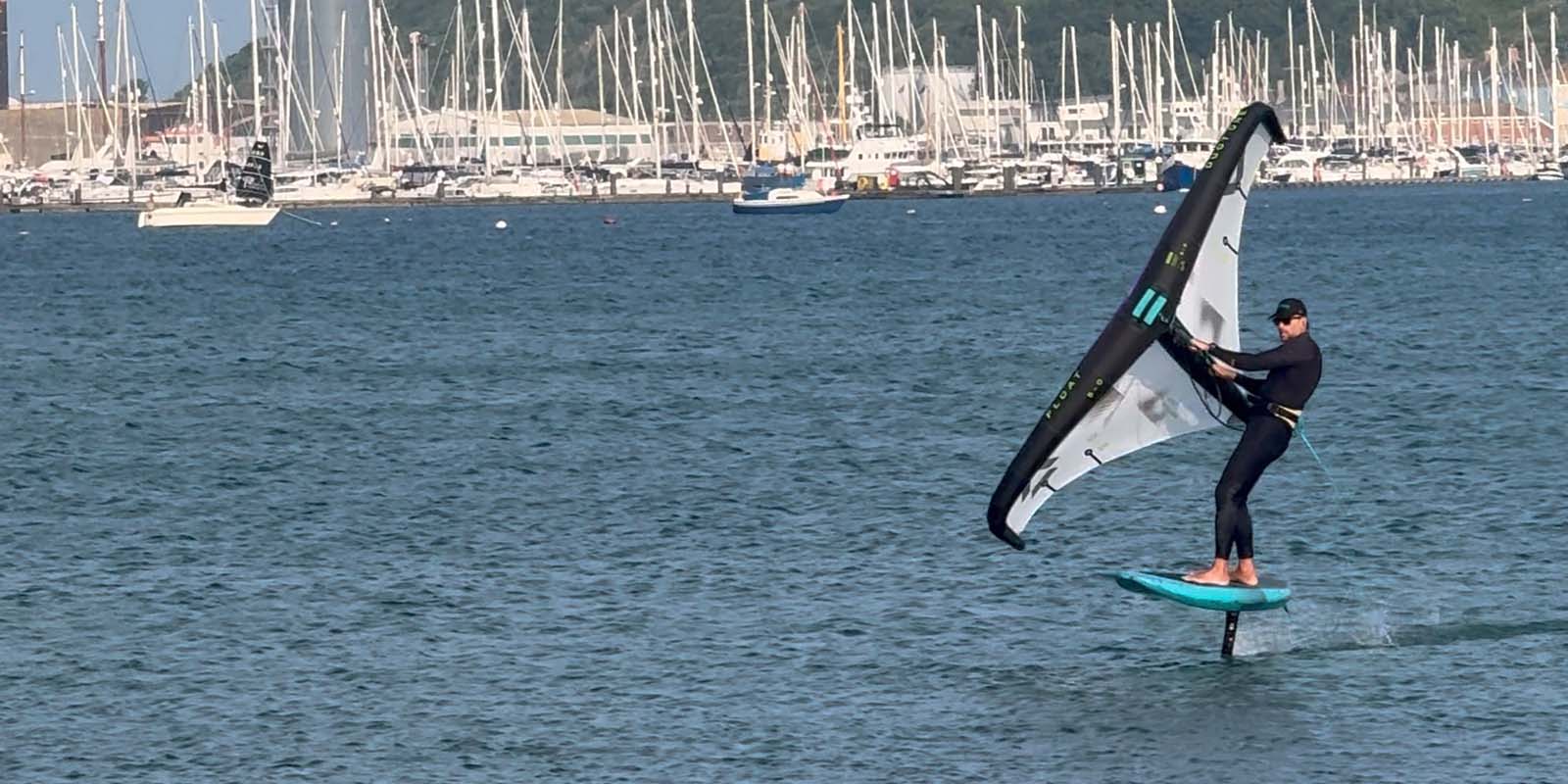 Wingfoil with boats behind in Portland harbour